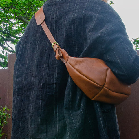 Tan leather Sling Bag crafted by Paula Kirkwood.