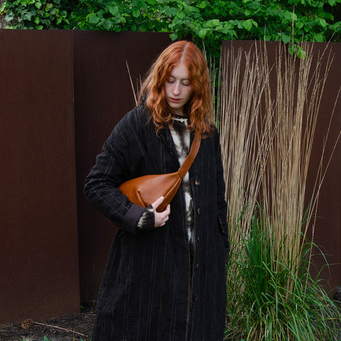 Tan leather Sling Bag crafted by Paula Kirkwood.